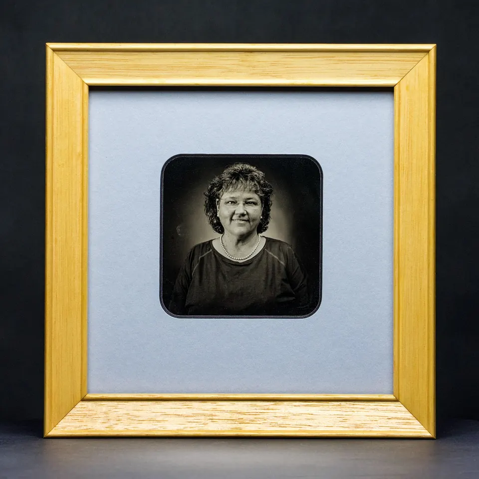 Gerahmte Daguerreotypie: Porträt mit lockigem Haar und leichtem Lächeln.