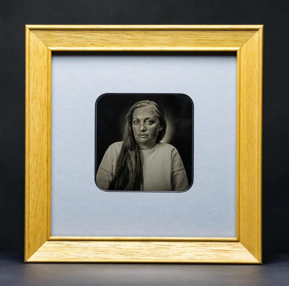 Gerahmte Daguerreotypie: Porträt mit langem Haar und direktem Blick.